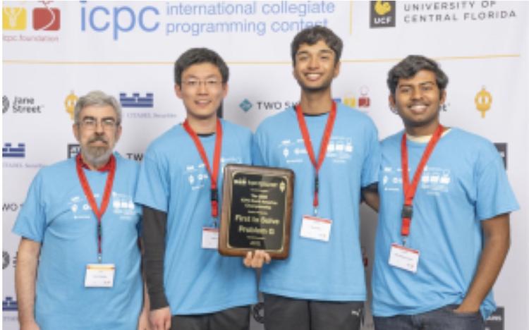 Picture of three members of Tortellini team and their coach.